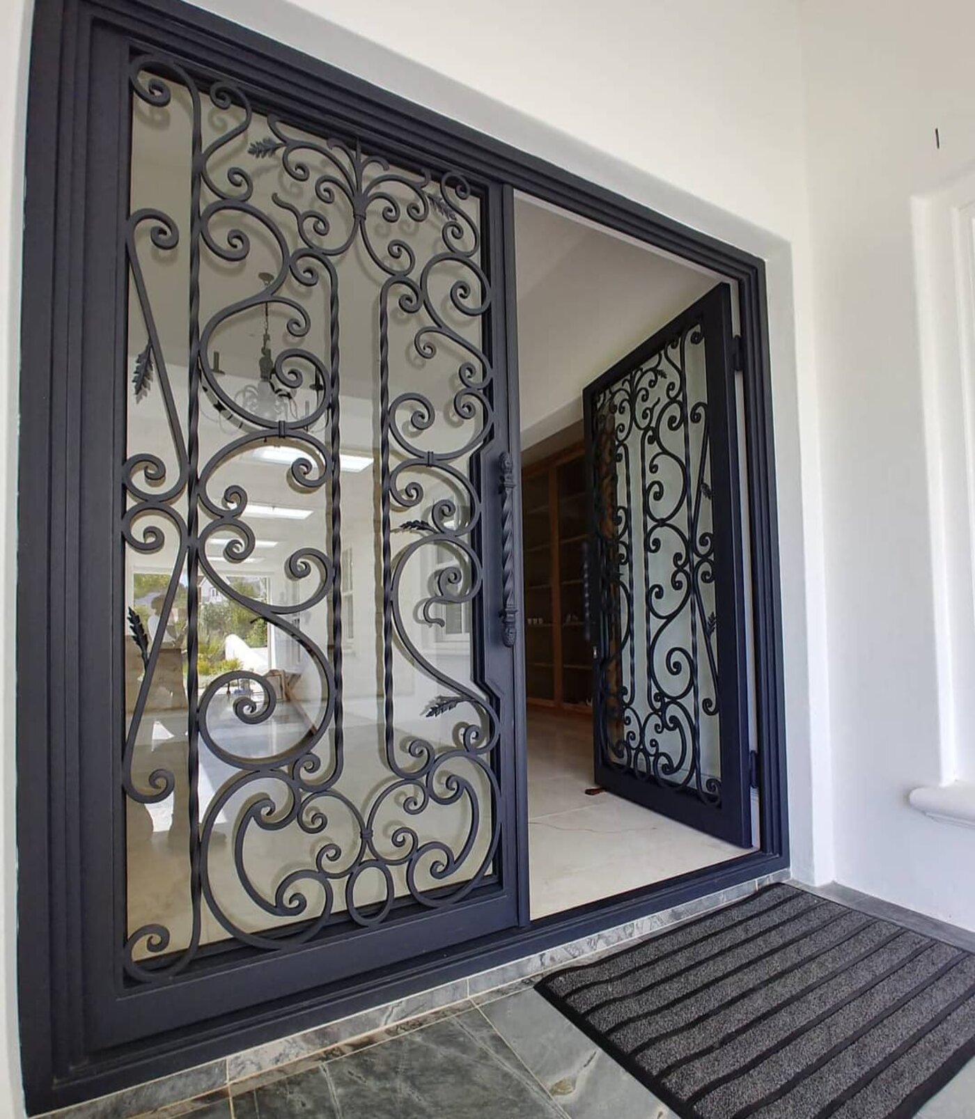 Custom scrollwork wrought-iron sliding security door by Palmers Exclusive Gates